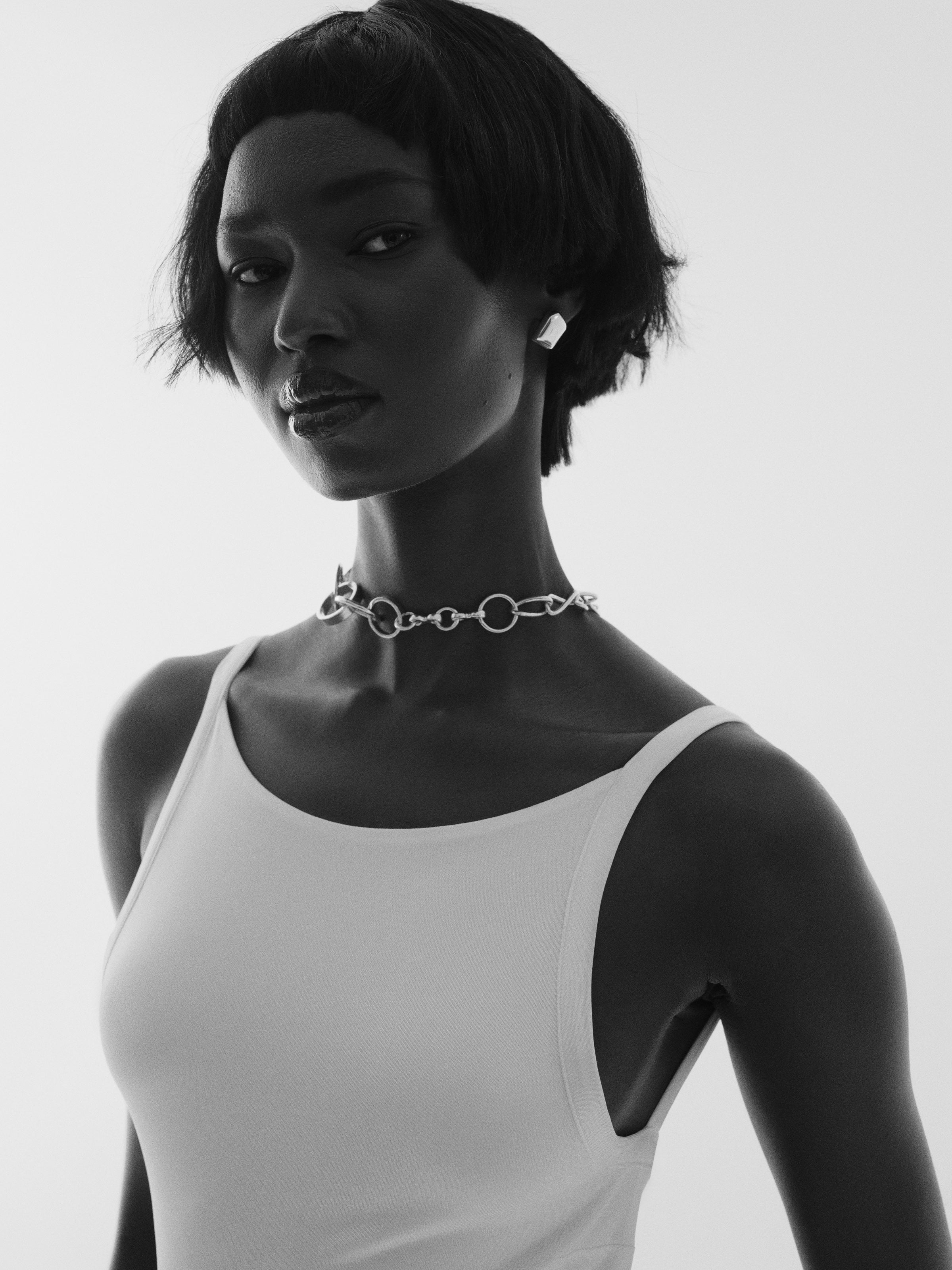 Model wearing sculptural silver Annabel B necklace and earrings