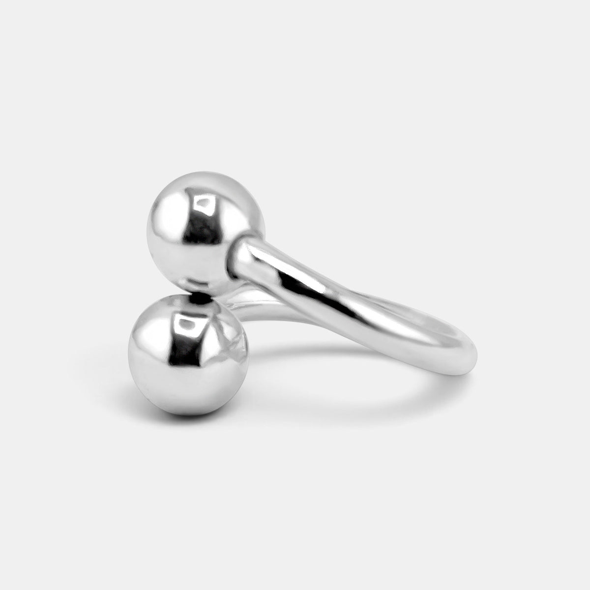 annabel-b sculptural sterling silver ring featuring two polished spheres positioned diagonally on a plain background