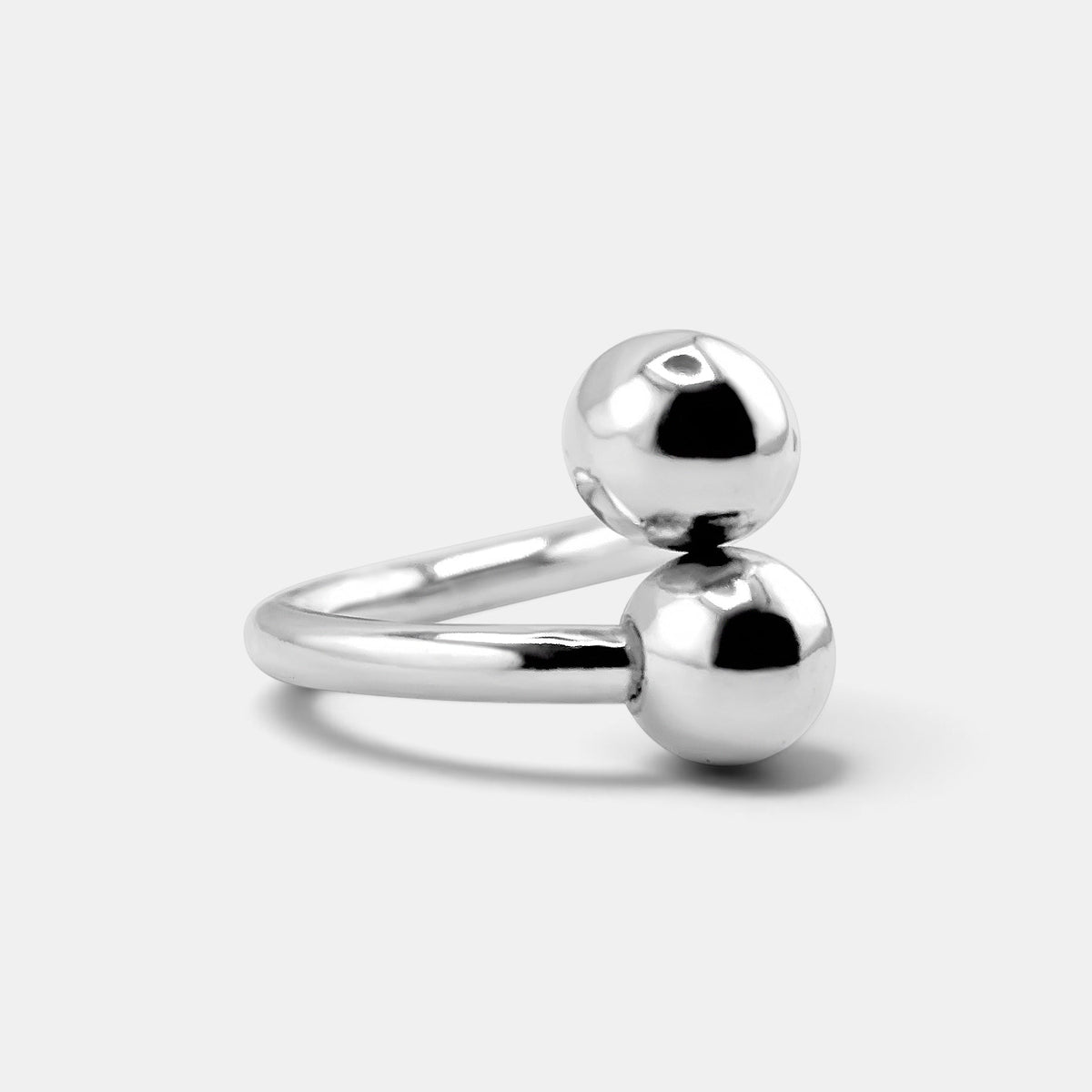 annabel-b sculptural sterling silver ring featuring two polished diagonal spheres in a minimalist modern design
