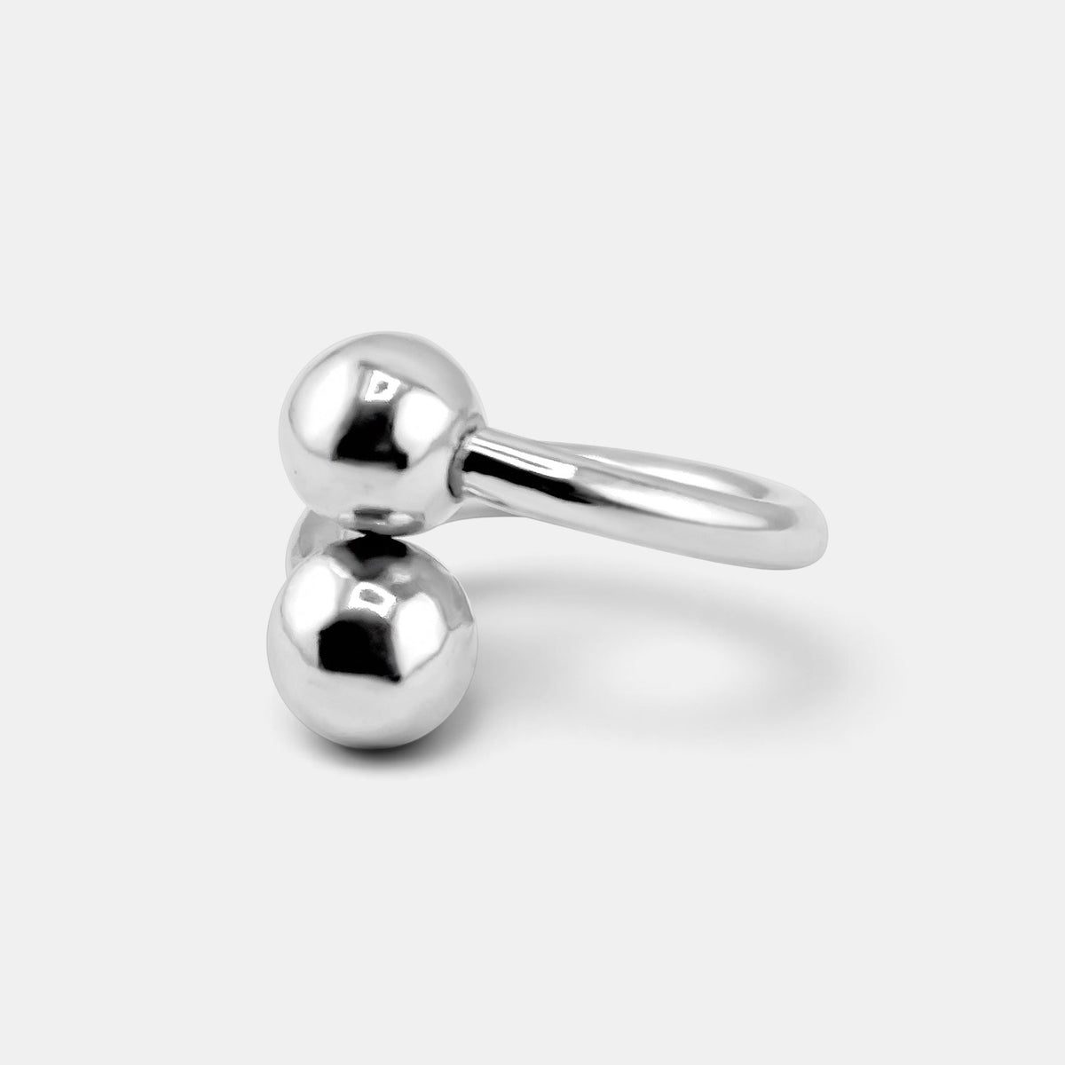 annabel-b sculptural sterling silver ring featuring two polished diagonal spheres in a modern minimalist design