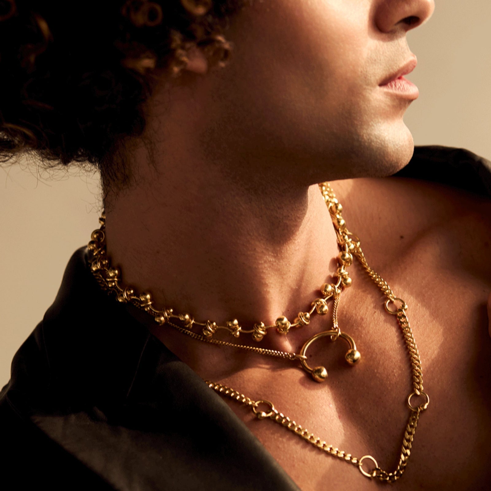 Model wearing the Barbell, Simply Pierced and Piercing Chain necklaces in gold vermeil